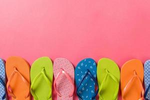 a lot of flip flop colored sandals, summer vacation on colored background, copy space top view photo