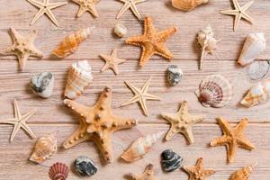 Starfish and seashells background on a wooden table, top view, flat lay photo