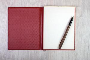 Open Notebook With White Pages And Gold Fountain Pen photo