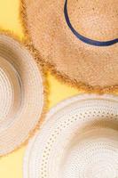 top view of straw beach hat on yellow background photo