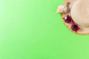 summer holiday beach background with accessories on green table, top view with copy space. vacation concept photo