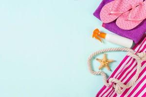Summer bag background with copy space. Flat lay photo on color table, travel concept. Free space for text, mock-up
