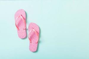 pink flip flops on blue background. Top view with copy space photo
