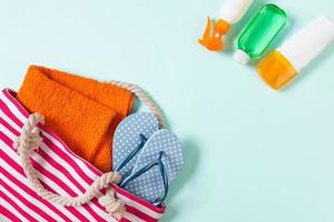 Summer bag background with copy space. Flat lay photo on color table, travel concept. Free space for text, mock-up
