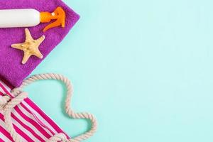Summer bag background with copy space. Flat lay photo on color table, travel concept. Free space for text, mock-up