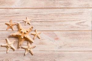 Starfish, seashells on a wooden table, top view, flat lay with copy space photo