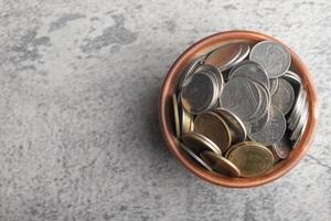 Coins in wooden cup.Future saving money concept.Copy space. photo