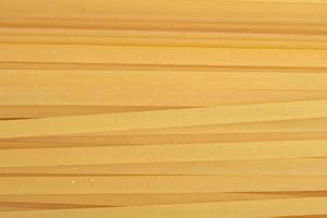 Yellow pasta lines for background.Close up. photo