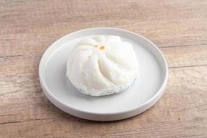 Steamed pork buns in a plate on a white background photo