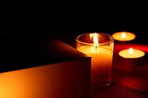 Scented candles in the dark night on a red cloth, ceremony, hope, romantic photo