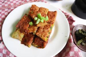 Martabak Telor or Murtabak Telur or mutabbaq. Savory pan-fried pastry stuffed with egg, meat and spices. Martabak Telur is one of Indonesia street food. photo