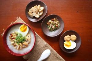 congee porridge with chicken slice, tofu, egg. congee porridge from hong kong. chinese food photo