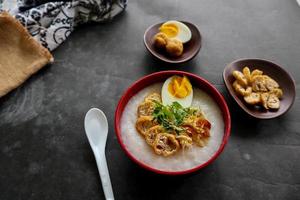 congee porridge with chicken slice, tofu, egg. congee porridge from hong kong. chinese food photo