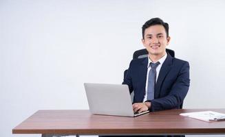 Image of young Asian businessman on background photo