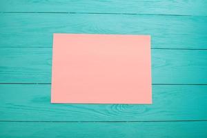 empty colored blank sheets of paper on wooden table close up photo