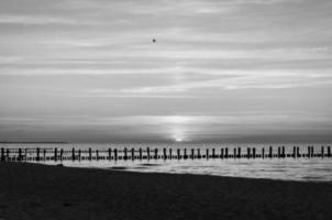 Sunset on the Baltic Sea in black and white. Sea, groyne strong colors. Vacation photo