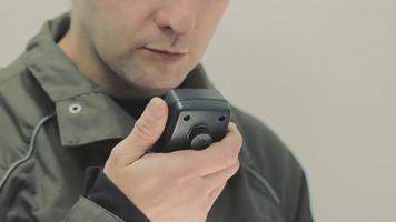 Close-up of a man talking on the radio. Two-way radio control communication video