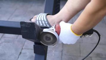 Man doing metal work using hand cutting machine tool video