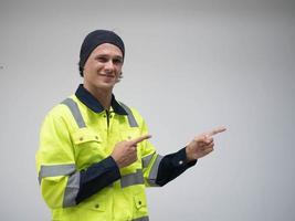 foreman engineer staff labor male person wear safety helmet uniform look at camera pointing finger cheerful white isolate background copy space empty happy smile service enjoy fun concept photo