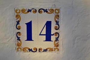Tile decorated with the number fourteen photo