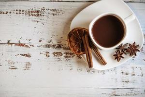 Coffee cup with spices on wooden table texture photo