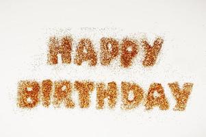 happy birthday inscription in bright sequins on white background photo