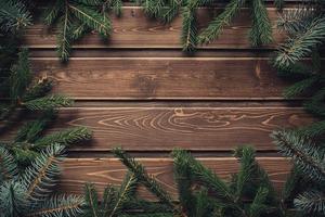 frame from branch of Christmas tree on old wood photo