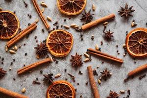 Dried orange, cinnamon sticks, anise star, cardamom. Traditional mulled wine with spices. Flat lay, top view photo