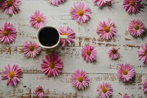 garden flowers, chrysanthemums coffee Cup and empty postcard on white wooden background with copy space for your text. Flatley, top view. photo