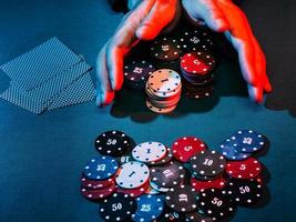 men's hands place a bet with playing chips photo