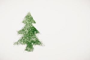 imagen de un árbol de navidad hecho de lentejuelas sobre un fondo blanco. vista superior, posición plana foto