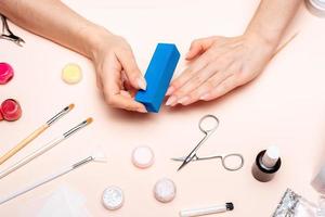 a young girl makes a manicure at home. Modern way of life. photo