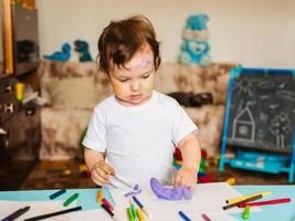 the boy is engaged in modeling from dough for modeling figures photo