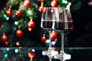 Glasses of wine on the background of a decorated Christmas tree. New year mood photo