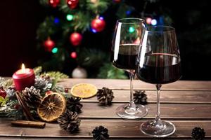 Glasses of wine on the background of a decorated Christmas tree. New year mood photo