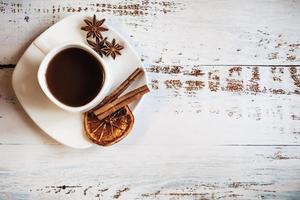 Coffee cup with spices on wooden table texture photo