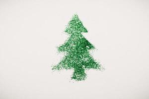 image of a Christmas tree made of sequins on a white background. Top view, flat position photo