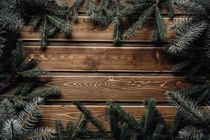 frame from branch of Christmas tree on old wood photo