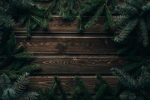 frame from branch of Christmas tree on old wood photo