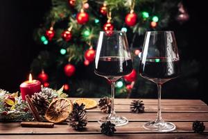 Glasses of wine on the background of a decorated Christmas tree. New year mood photo