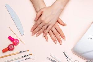 girl's hands on the background of manicure accessories. close up photo