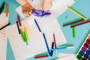 children's pens, colored pencils and markers and paints top view photo