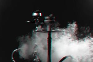 Hookah, shisha on a smoky black background with smoke. Glitch, black and white. Close up photo
