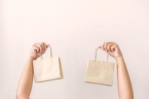 Woman carrying paper bag concept of reuse, recycle the object to zero waste. Concept of sustainability using of recycled paper bags for shopping. photo