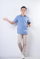 Full length image of young Asian man on white background photo