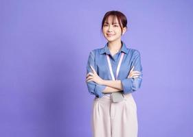 Image of young Asian business woman on purple background photo