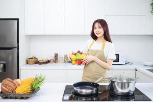 Image of young Asian woman in the kitchen photo