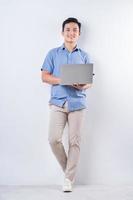 Full length image of young Asian man on white background photo