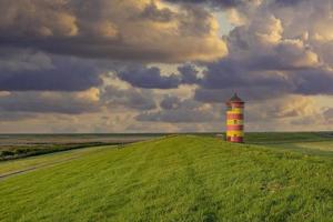 the famous Lighthouse of Pilsum at North Sea in East Frisia, Germany photo