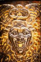 Medusa monster. Face of the Gorgon, gothic symbol of evil with snakes on hair. photo